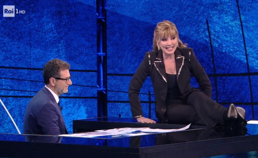 Che tempo che fa, Fabio Fazio stuzzica Milly Carlucci: «Posso togliere la busta?». Lei lo bacchetta